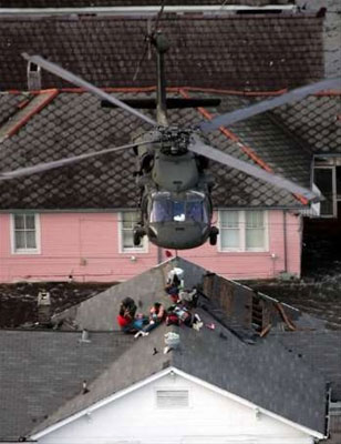 A National Guard Member prepares Hurricane Katrina residents for an air rescue