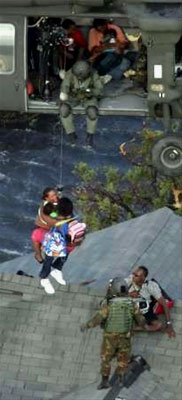 Two Hurricane Katrina survivors are rescued by National Guard members